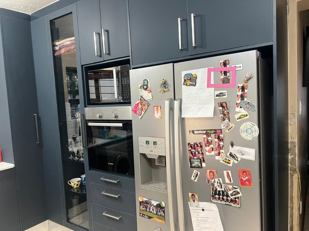 Counter run with subway tile backsplash and integrated appliances