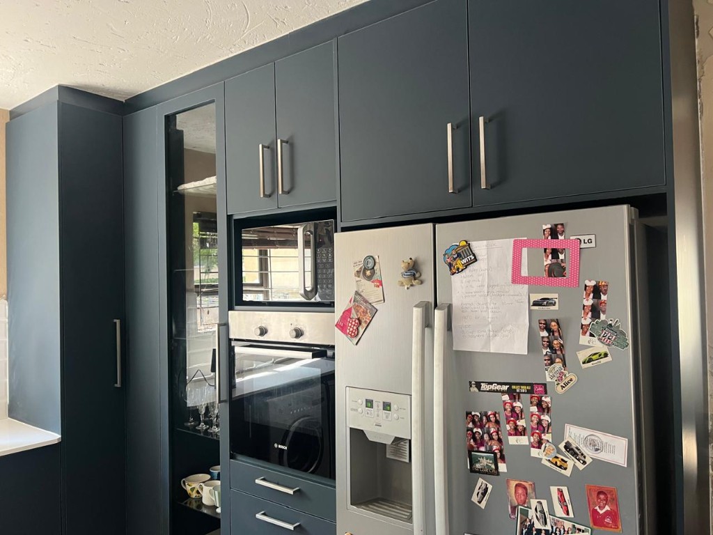 Island and full kitchen run in charcoal and white