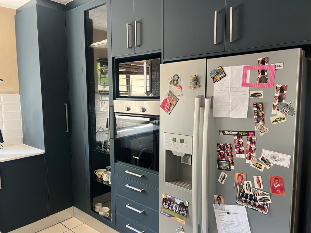 High angle of custom cabinetry with built-in microwave and oven